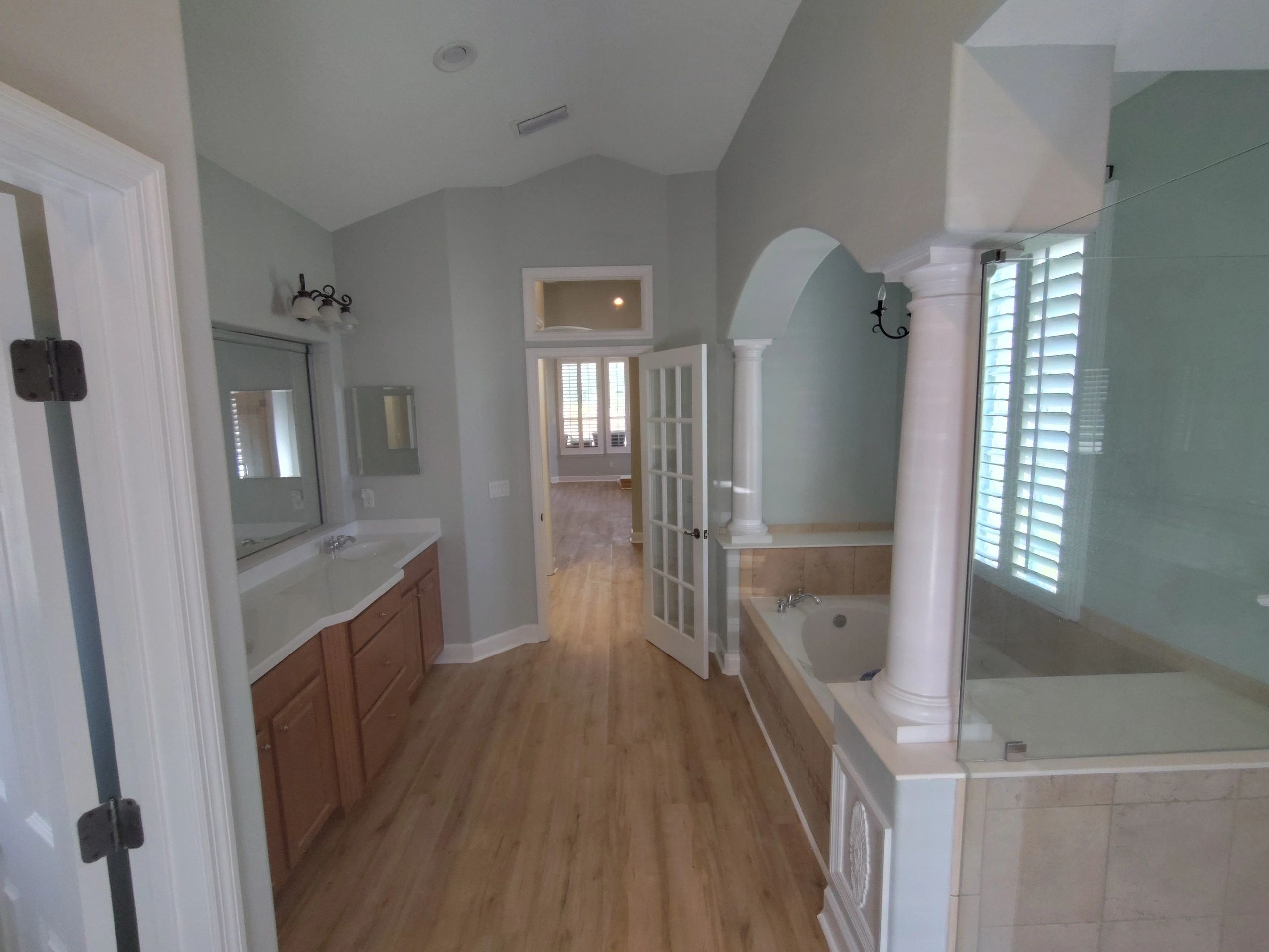 A large bathroom with a tub, sink, and shower