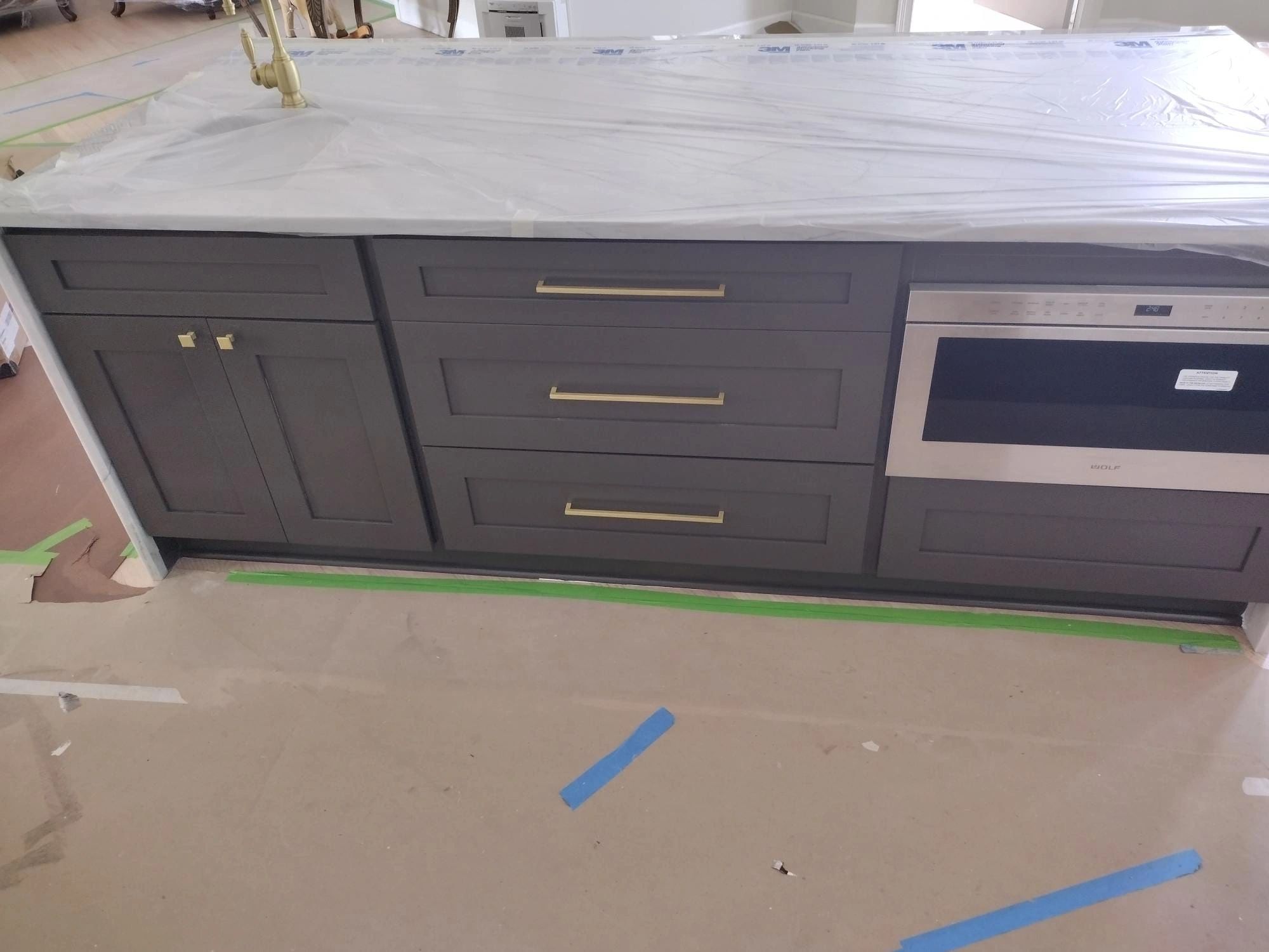 A kitchen counter with a microwave and oven in it