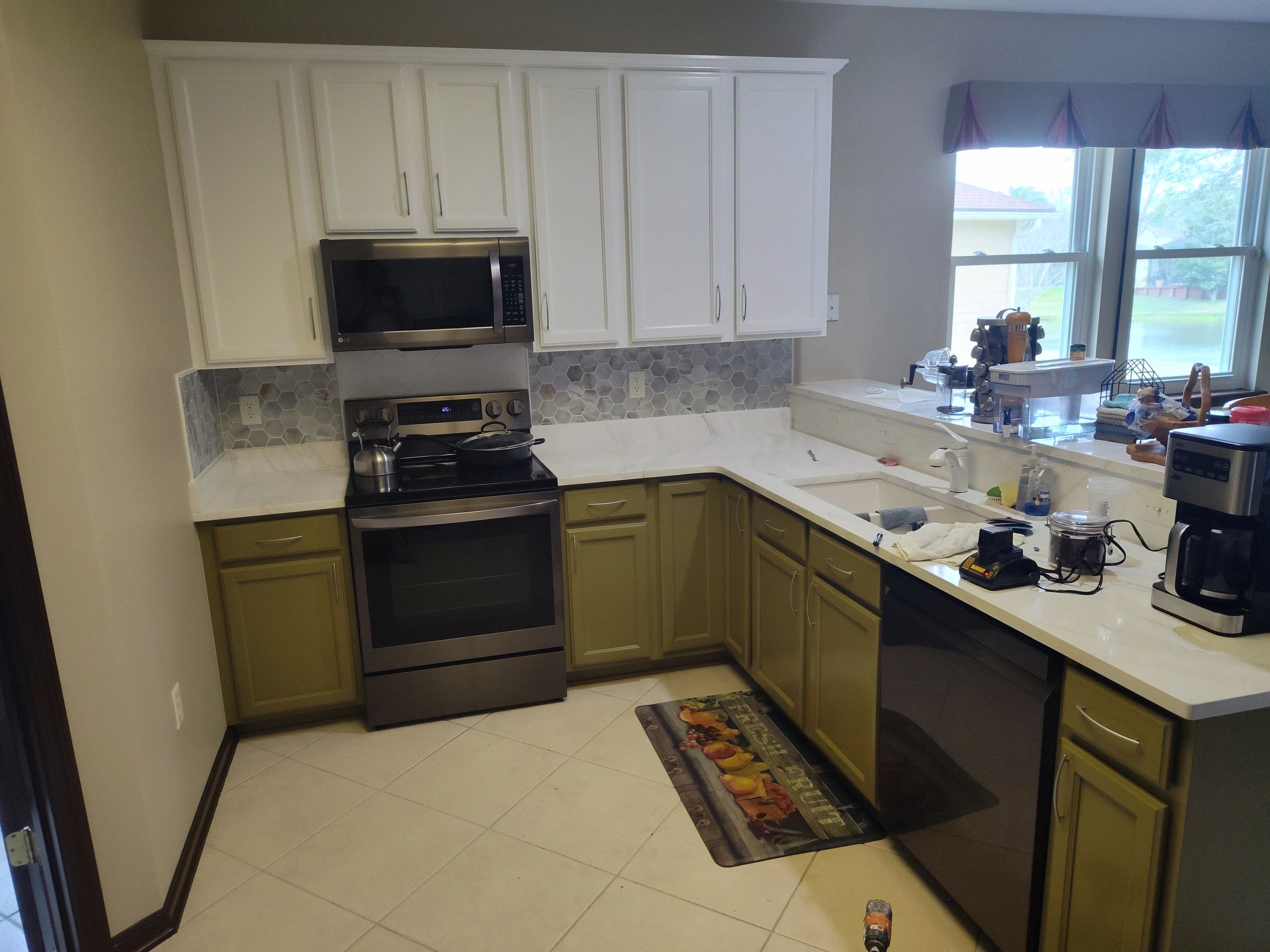 A kitchen with a stove, dishwasher, and microwave